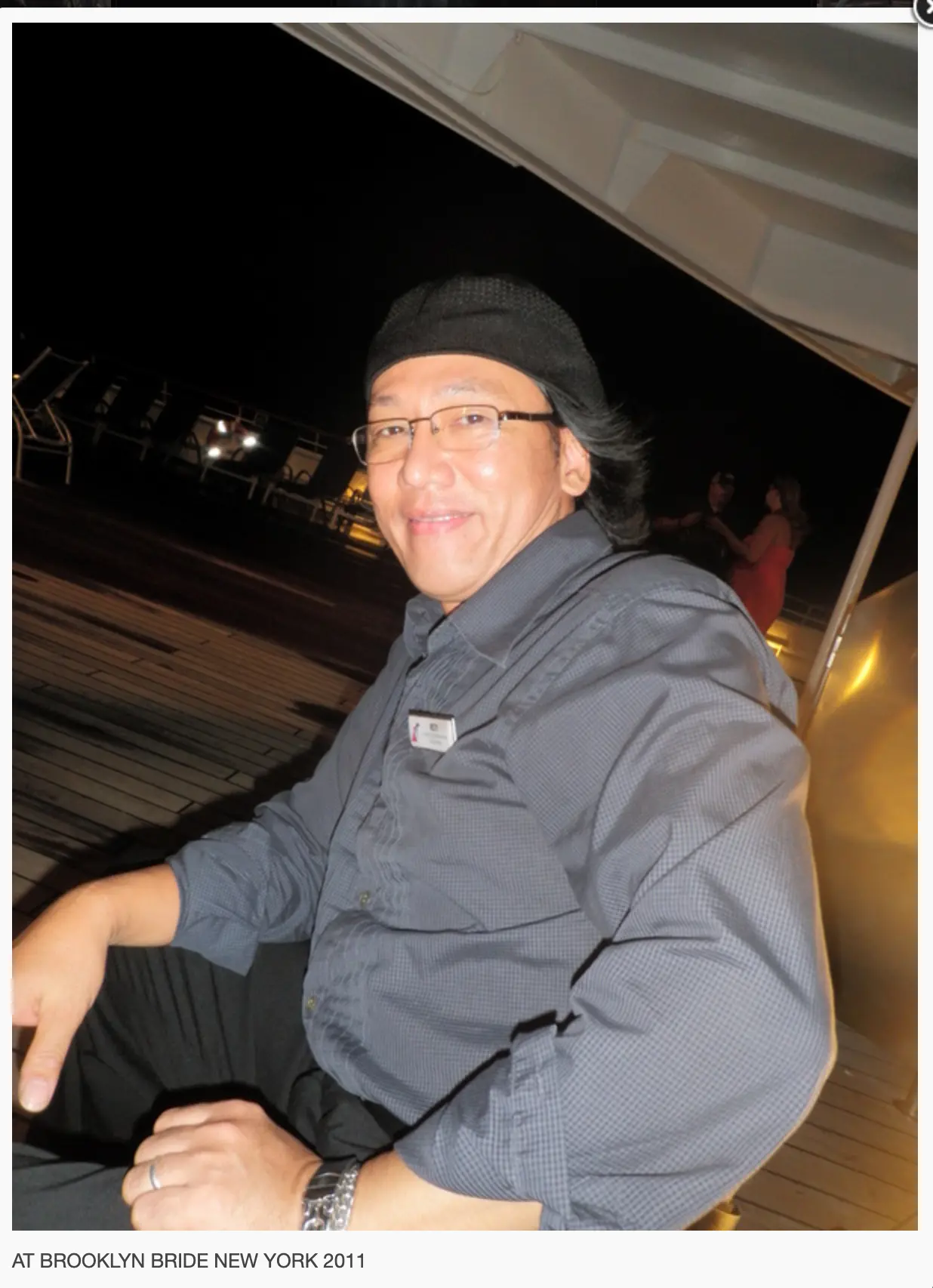 Resty Garcia on the deck of a cruise ship in New York, 2011, wearing his ship musician name badge