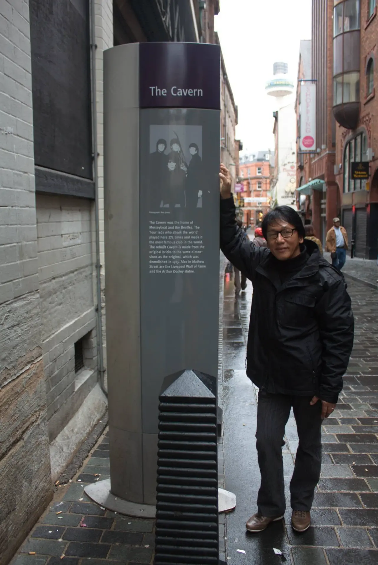 Resty Garcia beside The Cavern club marker on Mathew Street, Liverpool